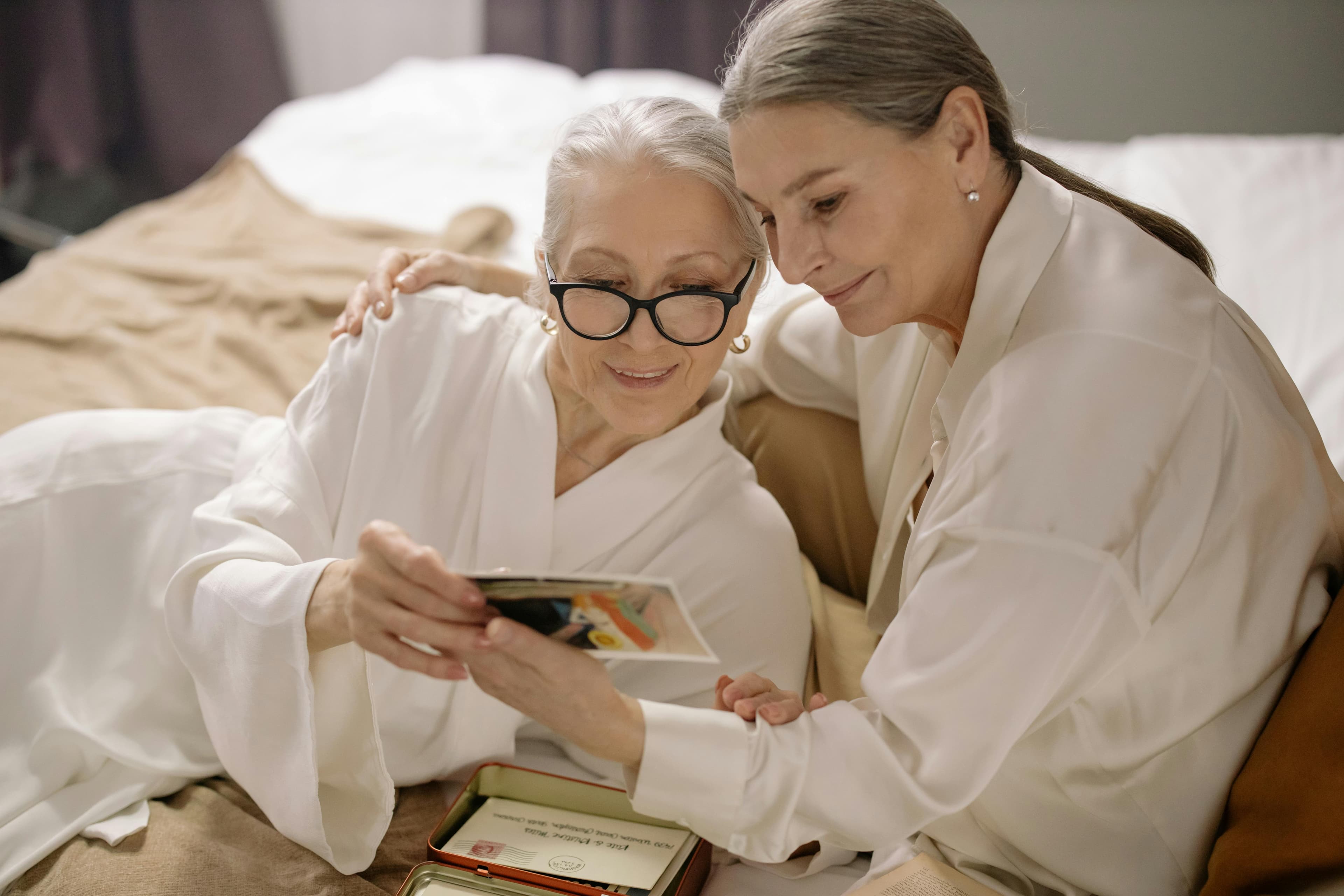 Two women reviewing family photographs together